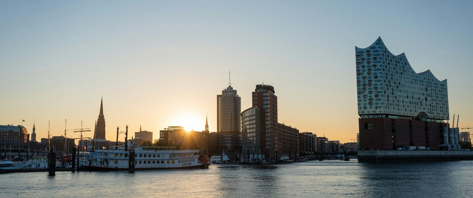 Hamburg city skyline across body of water during daytime